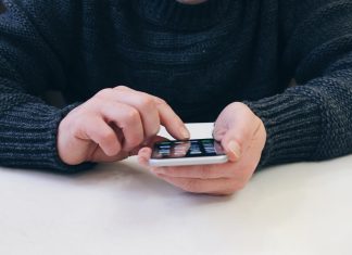 Megjött az Apple újdonsága! Mit kell tudni az iPhone 13-ról? Férfi iPhone-nal a kezébe